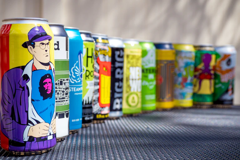 A row of colourful craft beer cans.