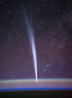 A bright nearly vertical streak in the night sky