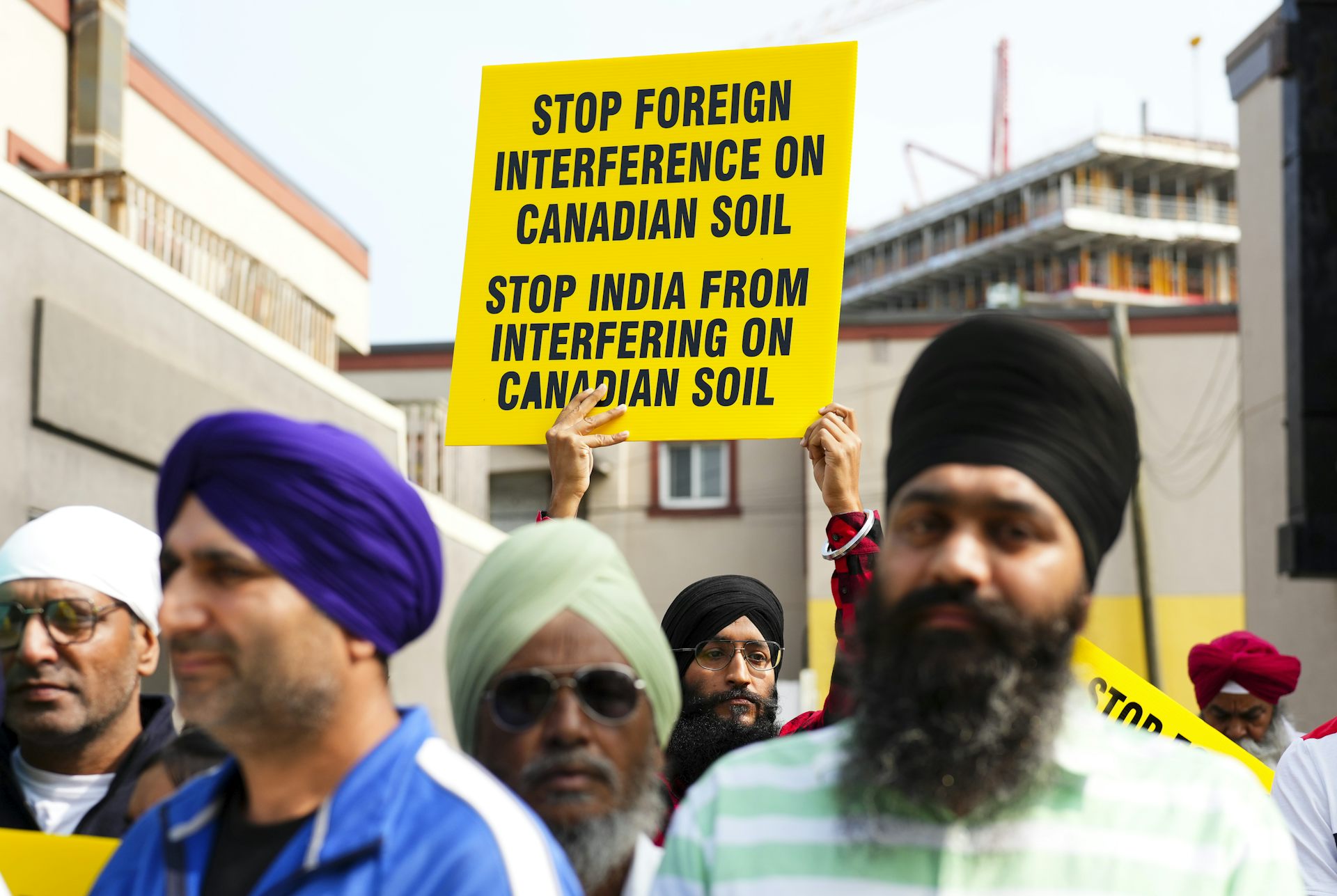 Men in turbans hold signs, one reading Stop India From Interfering on Canadian Soil
