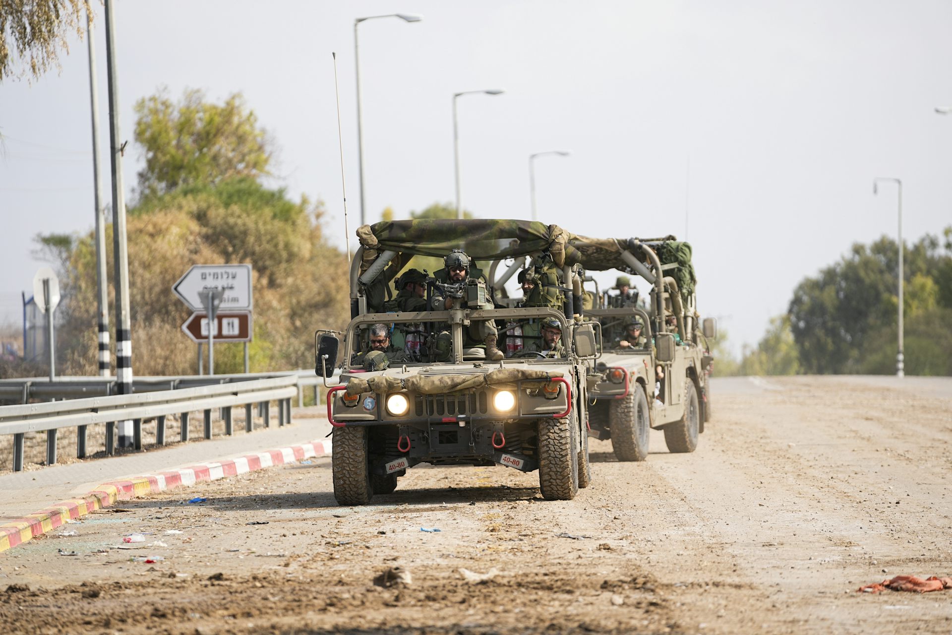 A military truck carrying armed soldiers.