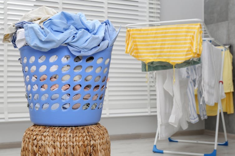 Washing and clothing dries on a rack indoors.