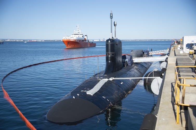 A photo of a submarine at dock.