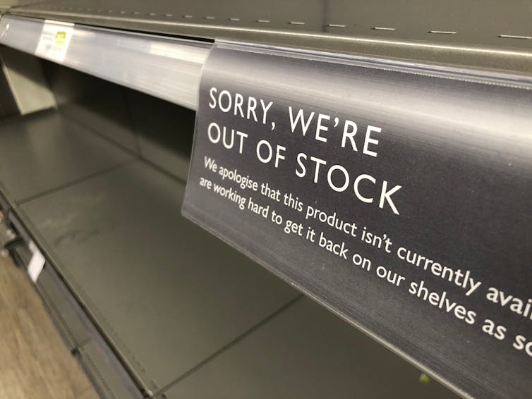 Out of Stock sign on a supermarket shelf.