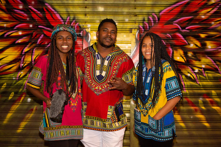 A man and two women standing
