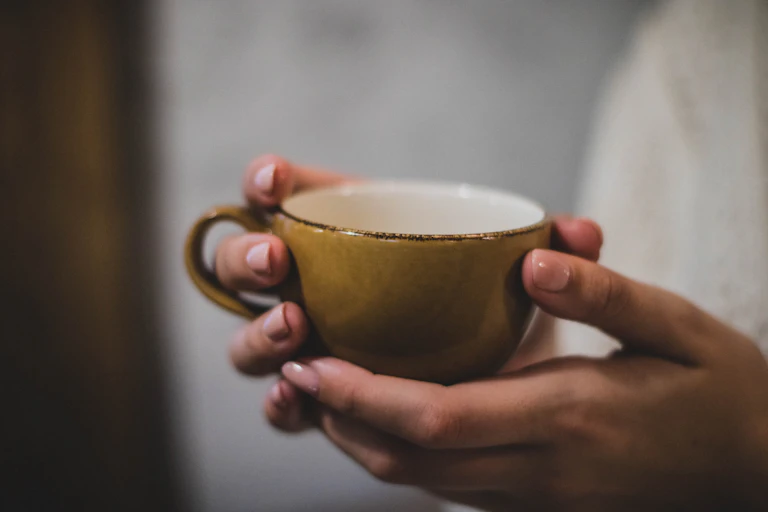 Woman holds coffee cup