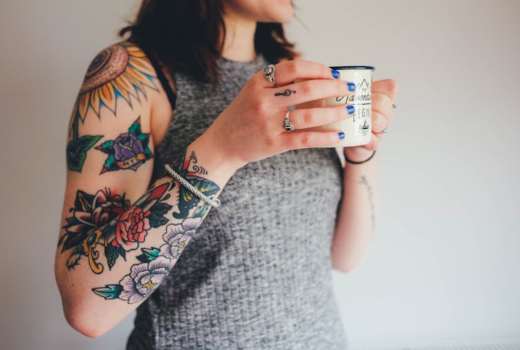 Woman holds coffee cup