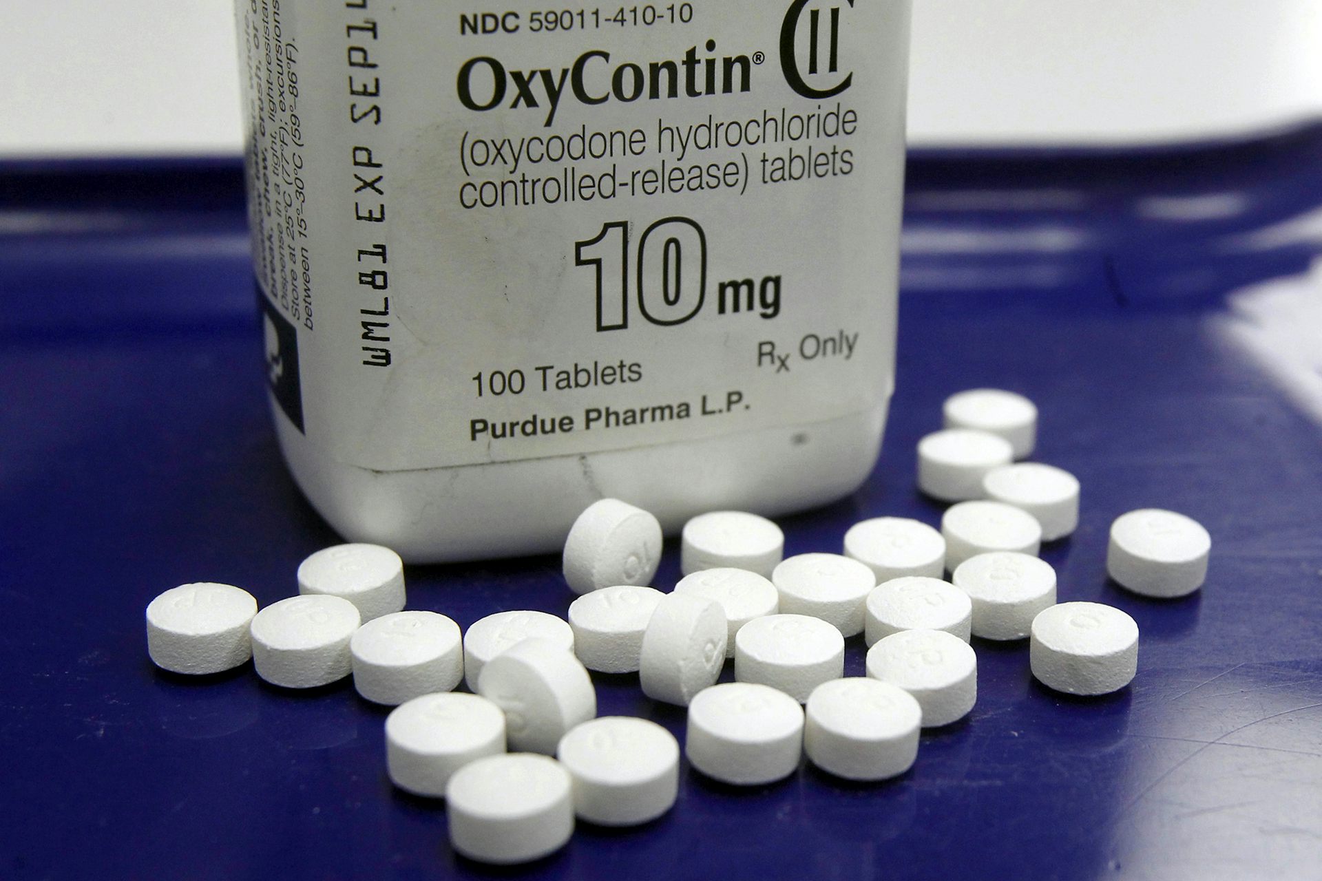A bottle marked OxyContin 10-milligram behind a small pile of tablets