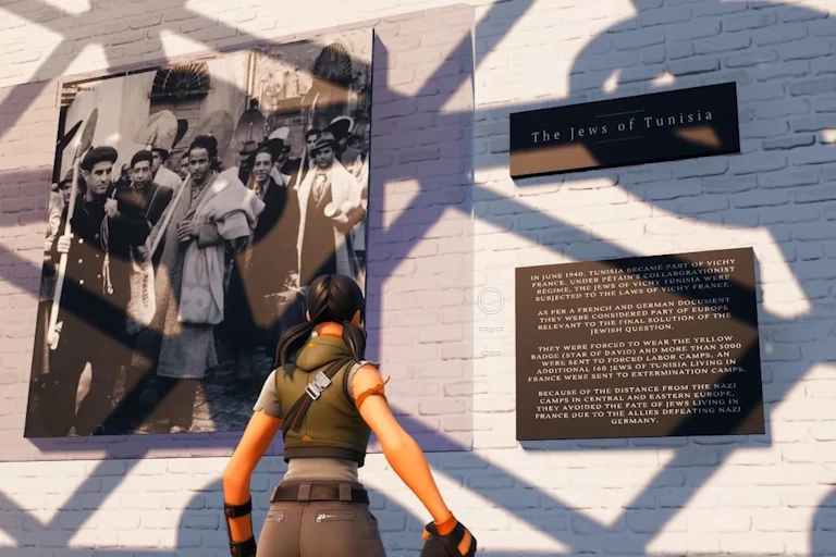 A game player looks at an exhibit on The Jews of Tunisia.
