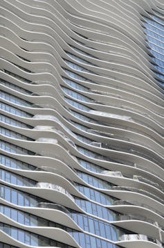 A skyscraper facade with curved balconies.