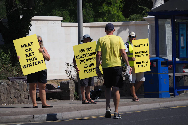 Protestors hold up yellow posters.