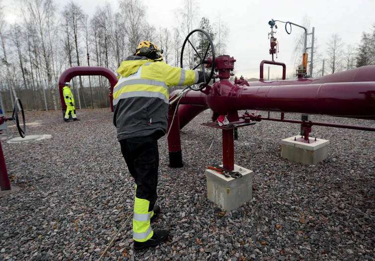 A man wearing a high viz jacket at a compression station of the Balticconnector marine gas pipeline in Inkoo, Finland.