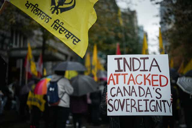 A person holds up a sign that reads India Attacked Canada's Sovereignty