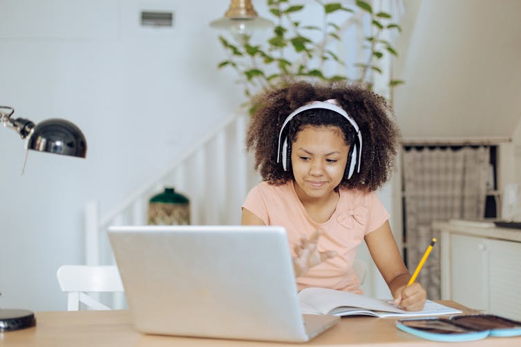 Teenage African American girl learning at home.