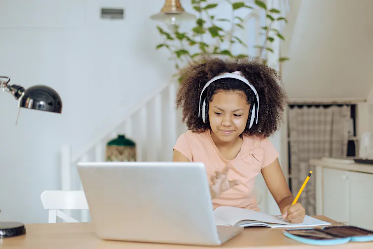 Teenage African American girl learning at home.