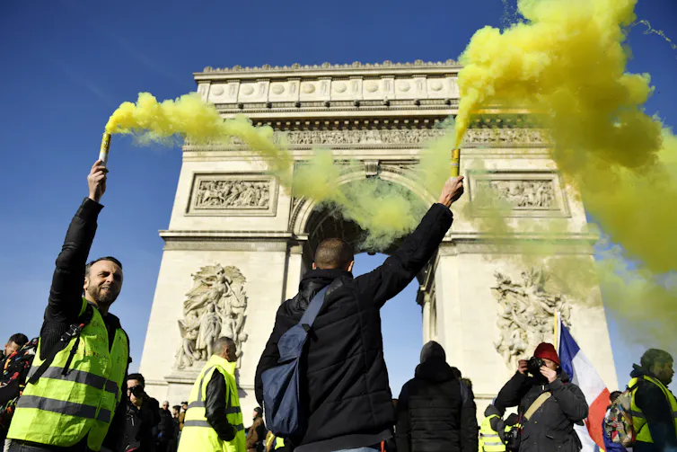 Protestors setting off flares in front of the Arc de Triomphe in Paris.