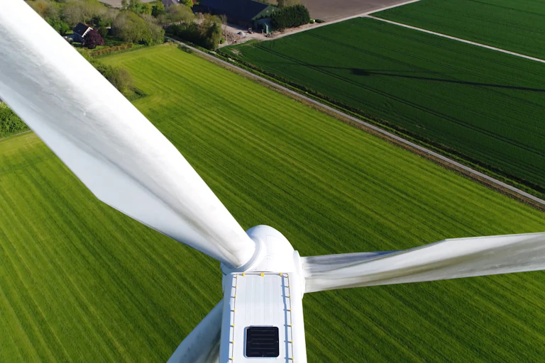 Wind turbine overlooking field