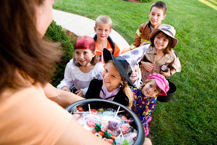 A group of kids trick or treating.