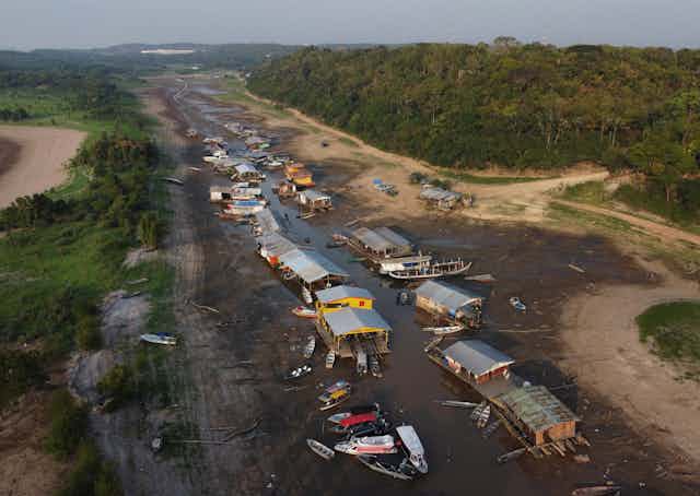 Dozens of boats stranded on a dry riverbed in the Amazon