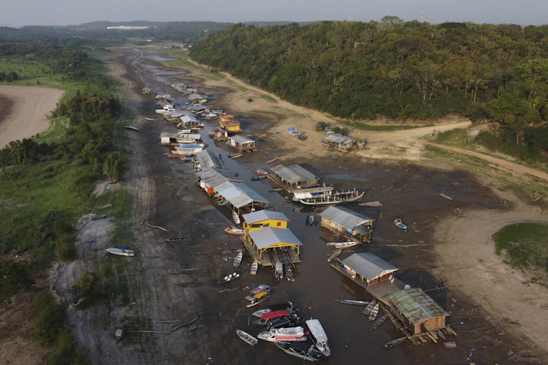 Dozens of boats stranded on a dry riverbed in the Amazon