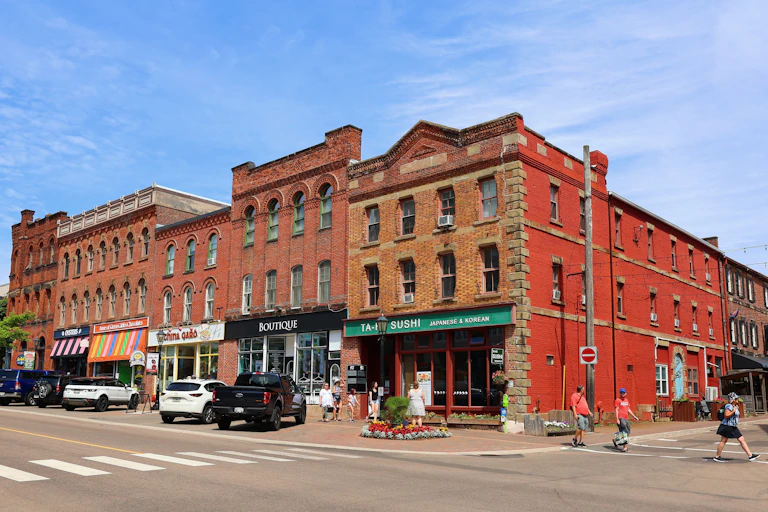 a row of red-brick buildings with retail on the ground floor