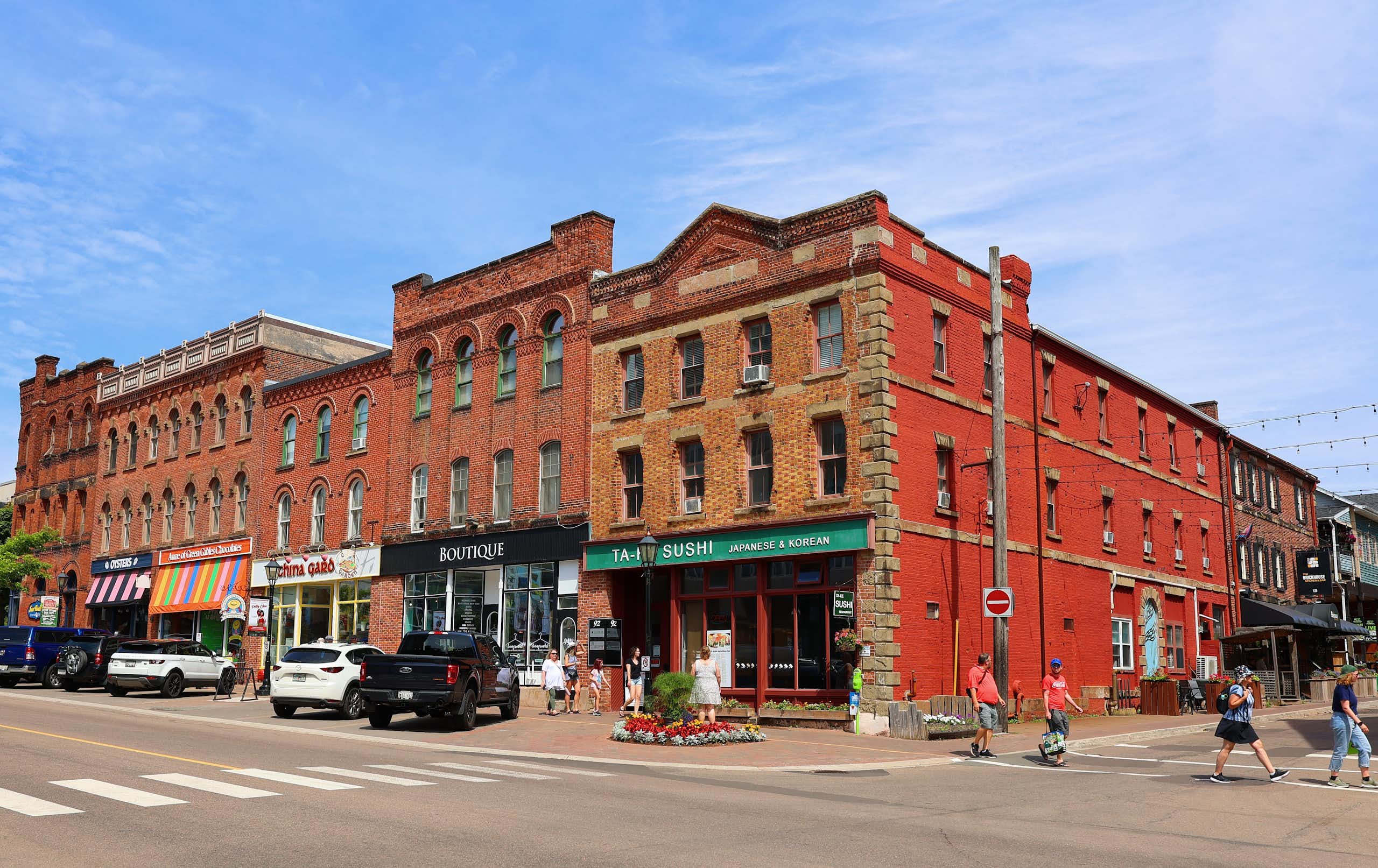 a row of red-brick buildings with retail on the ground floor