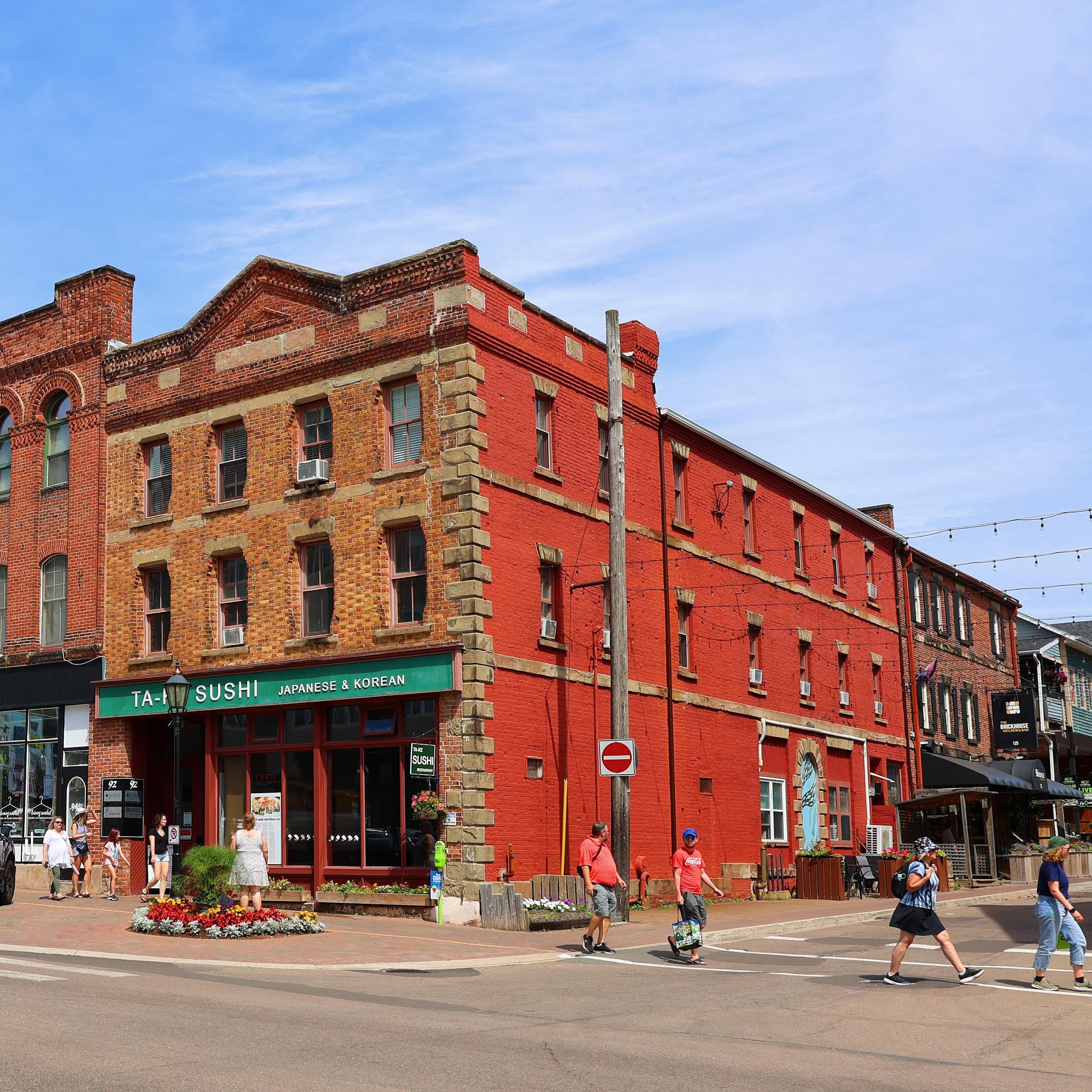 a row of red-brick buildings with retail on the ground floor