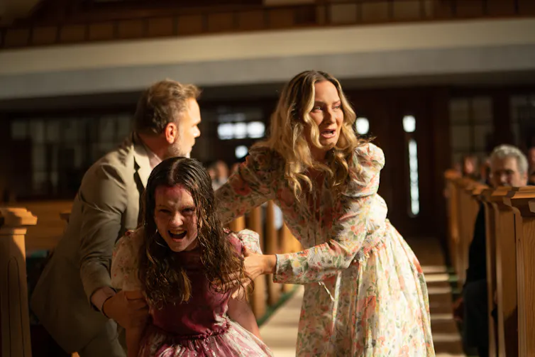 Production image: a possessed girl in a church.