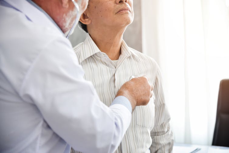 Doctor listens to patient's chest