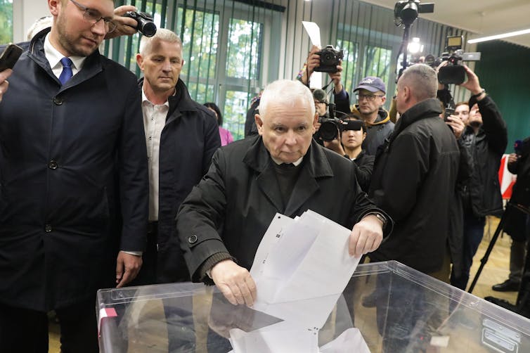 Jaroslaw Kaczynski putting his ballot into a ballot box.