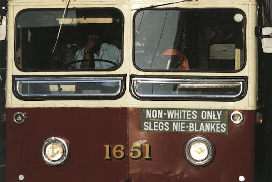 A bus displays the: 'Non whites only'. 