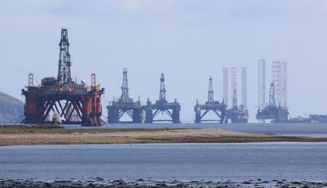 abandoned oil rigs in a shallow estuary
