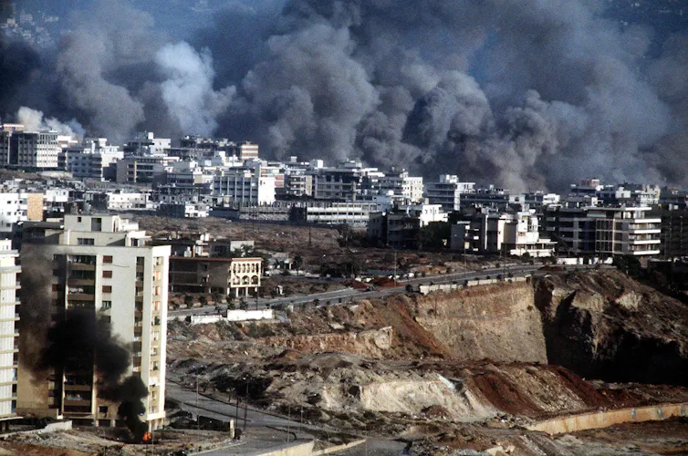 Smoke rising from cityscape of apartment blocks