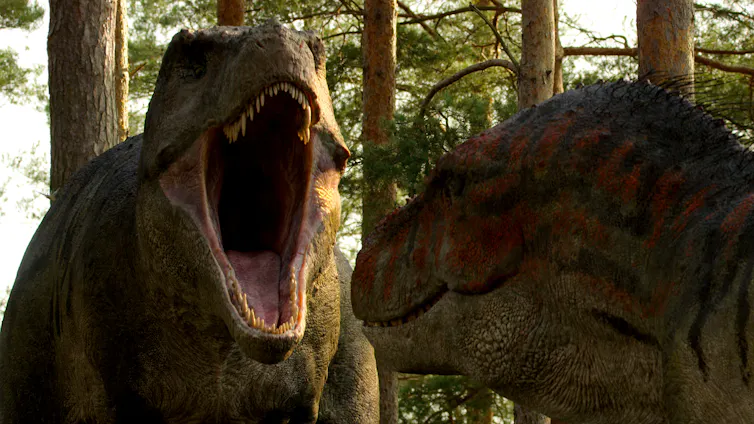 A t-rex screams at another dinosaur