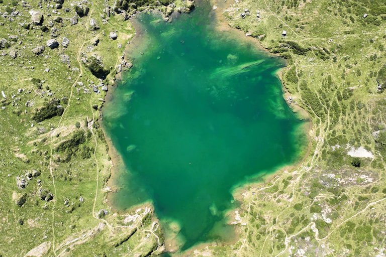 aerial view of a green mountain lake