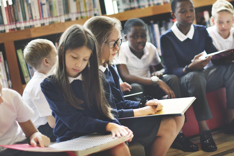 School children reading in library