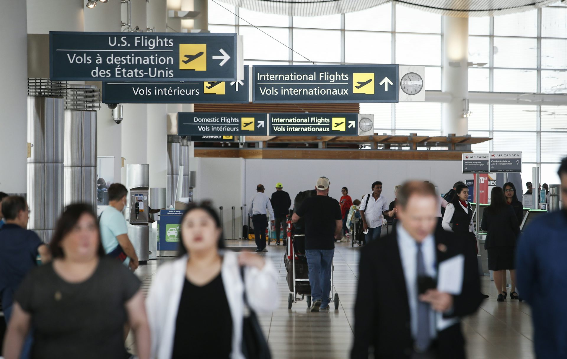 People walk through an airport