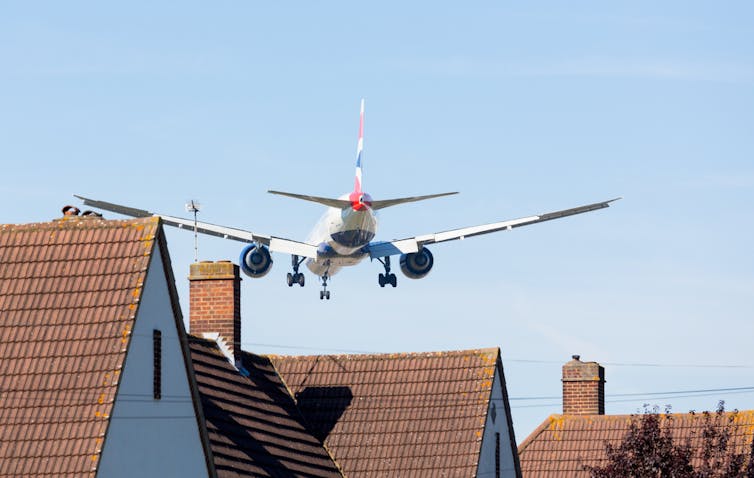 Plane flying low over houses