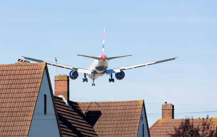 Plane flying low over houses