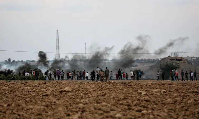 Smoke rising above protesters along the fence of the Israel border with Gaza.