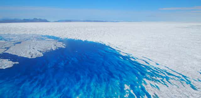 blue meltwater lake on ice sheet