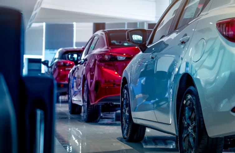 a red and blue car in a showroom