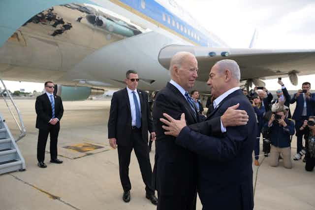 Joe Biden and Benjamin Netanyahu greet each other as Biden arrives in Israel, October 18 2023.