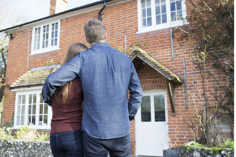 A couple looking at their home.