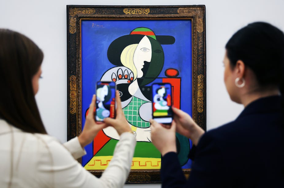 People photographing a Picasso painting.