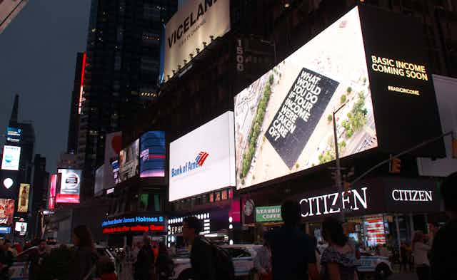 Electric billboards in New York street at night