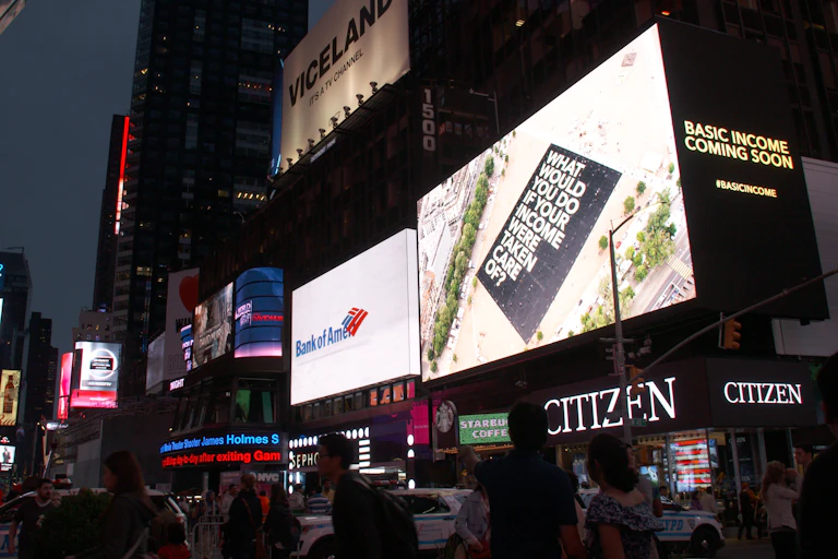 Electric billboards in New York street at night