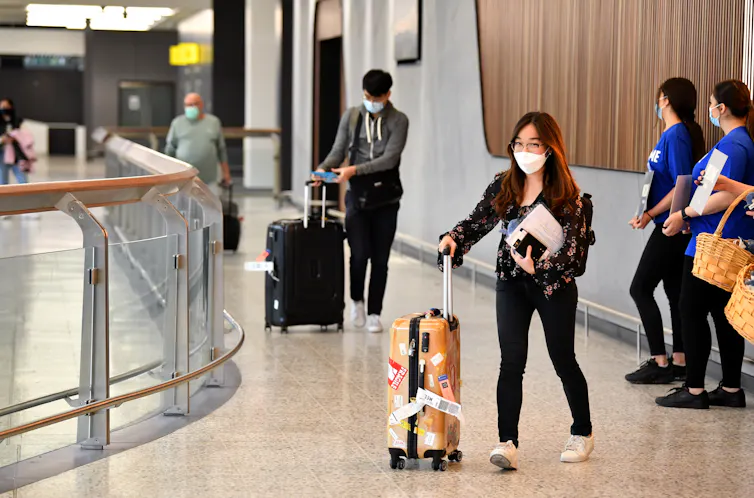 Travellers arrive at Sydney airport.