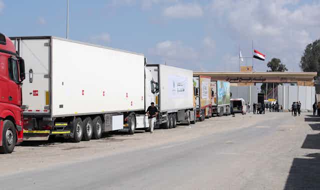 Lorries queue at a border crossing between Egpyt and the Gaza Strip, October 20 2023.