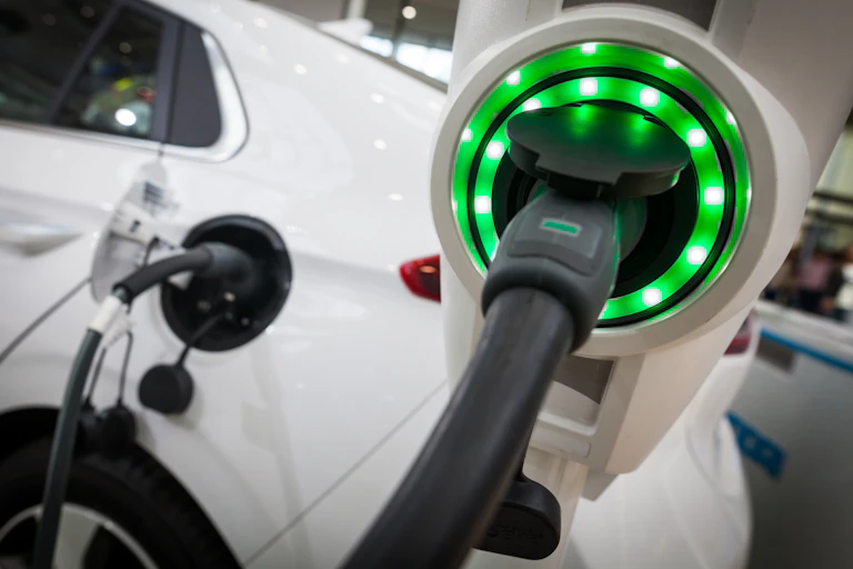 Electric vehicle being charged at a charging station