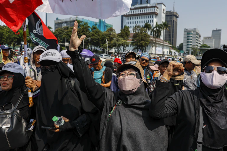 Masked people in a large protest.